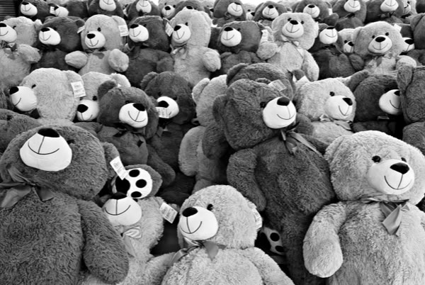 A large group of teddy bears arranged closely together.