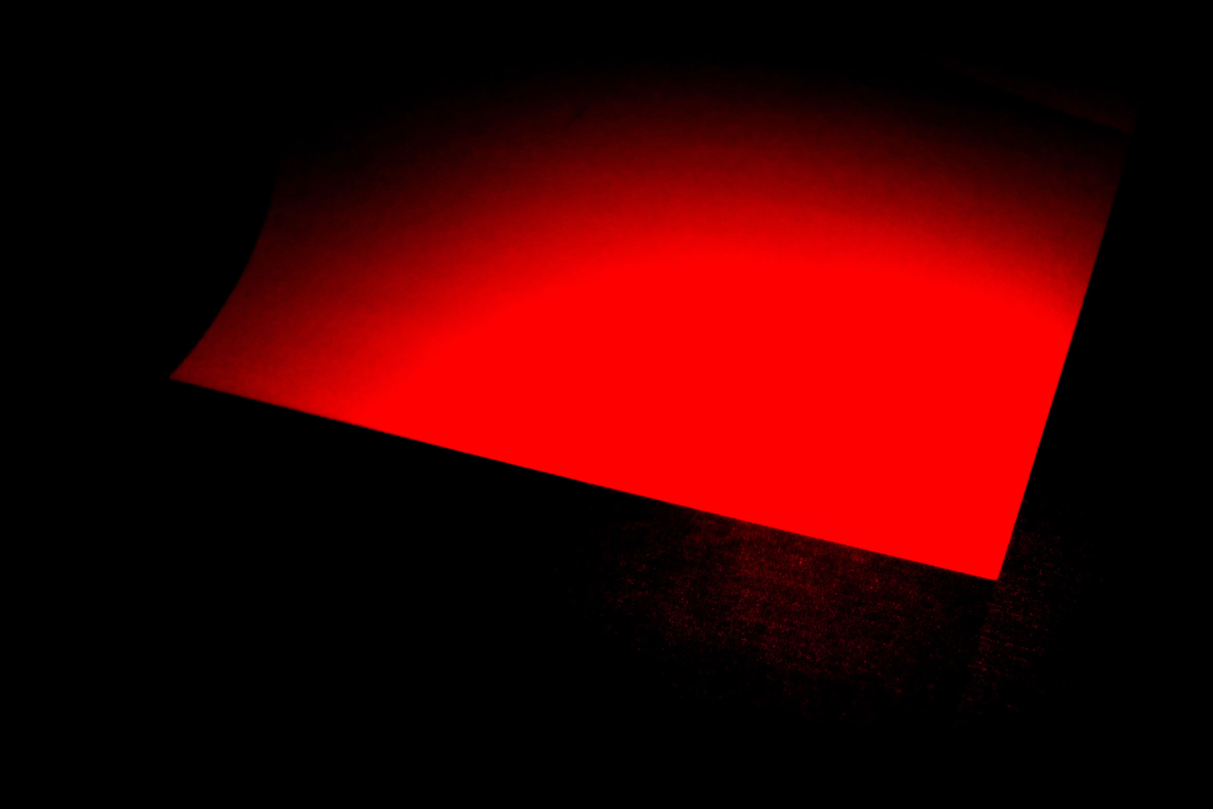 A red rectangular shape on a black background.